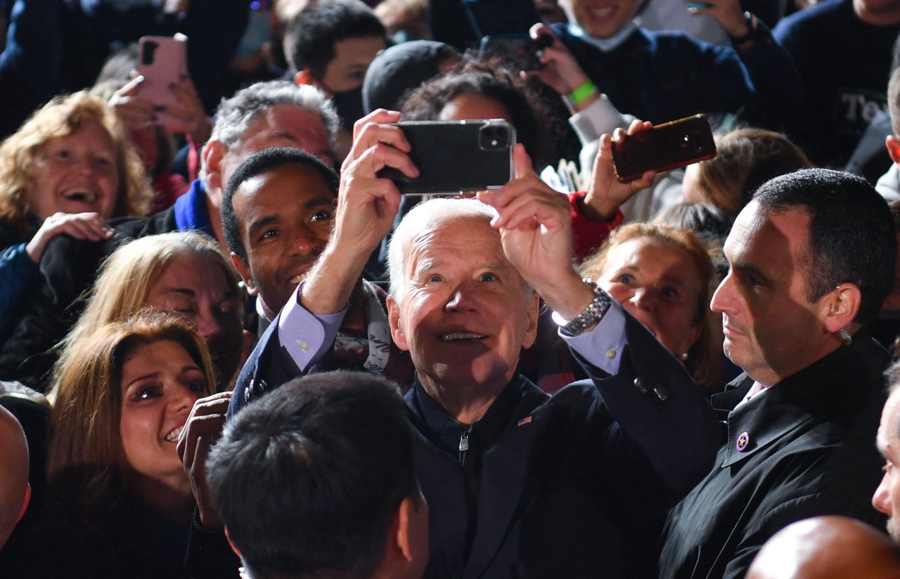 U.S. President Joe Biden takes selfies with a crowd after a campaign event for Virginia Democratic gubernatorial candidate Terry McAuliffe at Virginia Highlands Park in Arlington, Virginia, on Tuesday.