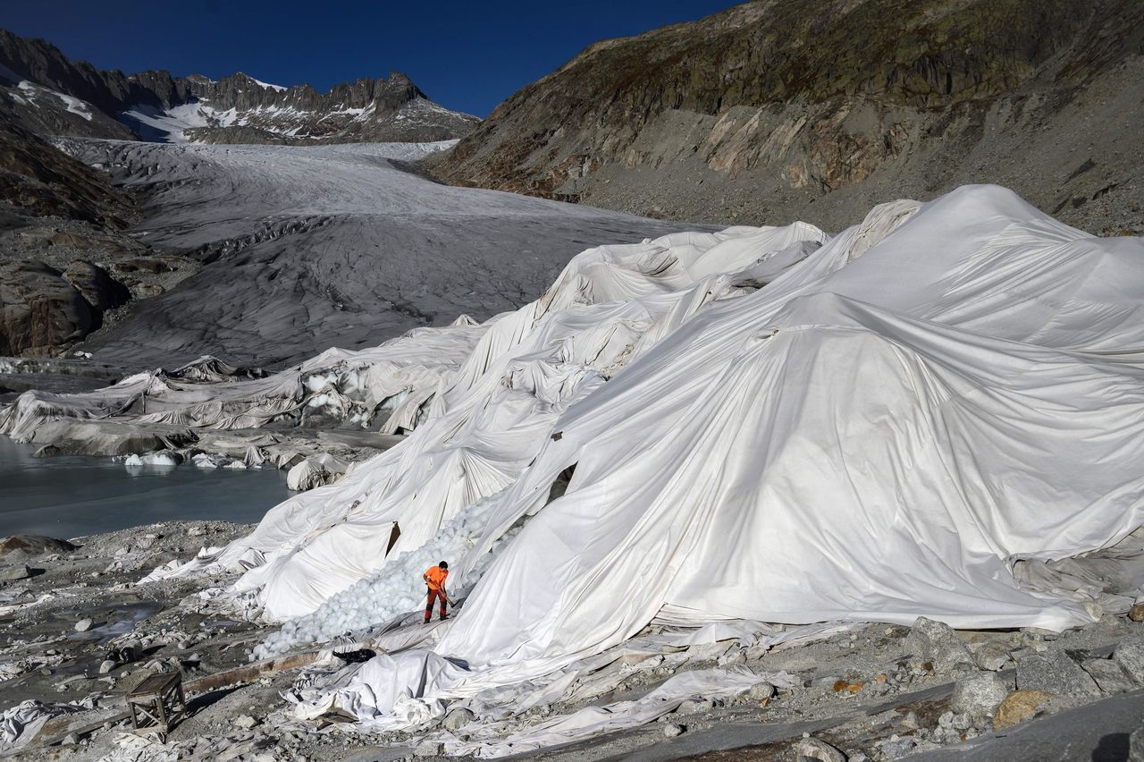 A man works at the Rhône Glacier, which is partially covered with insulating foam to prevent it from melting due to global warming, near Gletsch, Switzerland, on Wednesday.