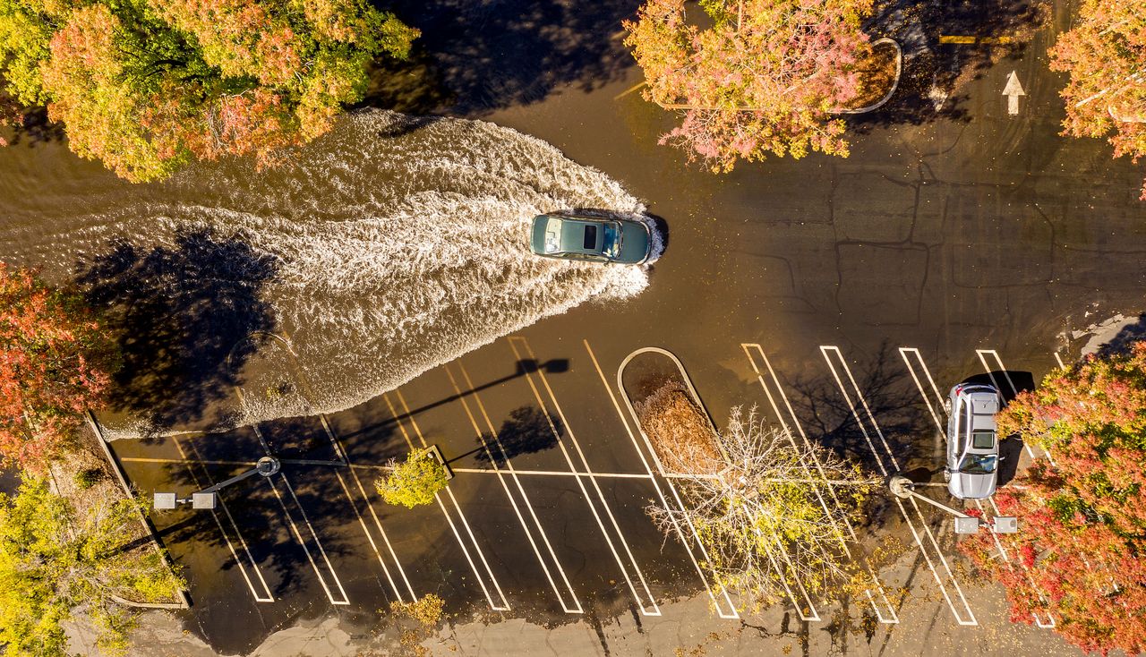 A car crosses a flooded parking lot in Oroville, California, on Monday. A massive storm barreled toward Southern California after causing flooding across the northern half of the state.