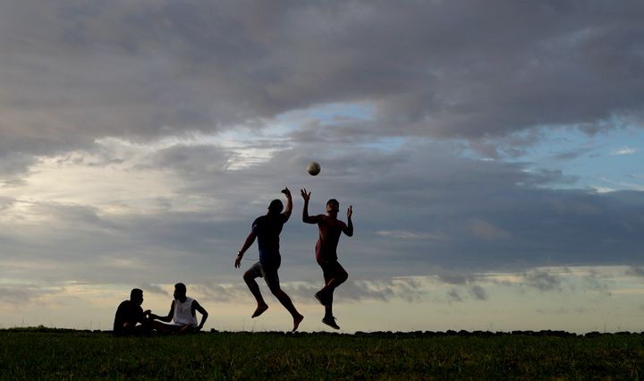 Young men play a game of rugby at sunset in Nuku'alofa, Tonga, on Wednesday, April 10, 2019 in this file photo. (AP Photo/Mark Baker, File)