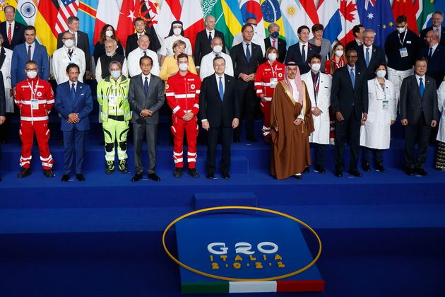 epa09553685 World leaders pose for a group photo with medical personnel during the G20 summit at the...