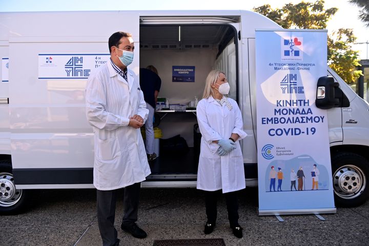 Medical staff stand outside a mobile COVID-19 vaccination team set up by Health Ministry in the northern city of Thessaloniki, Greece on Tuesday, Oct. 26. 2021. Local authorities are on alert in the region following a spike in COVID-19 infections hitting areas with low vaccination coverage. (AP Photo/Giannis Papanikos)