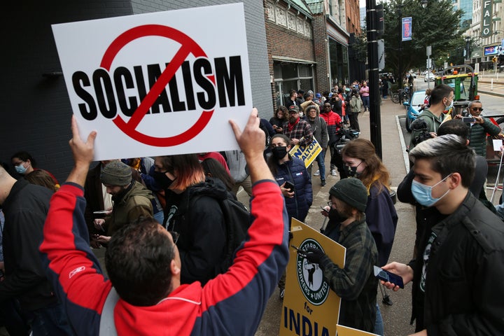 A protester outside Walton's Oct. 23 rally with Rep. Alexandria Ocasio-Cortez in downtown Buffalo illustrates what Walton is up against.