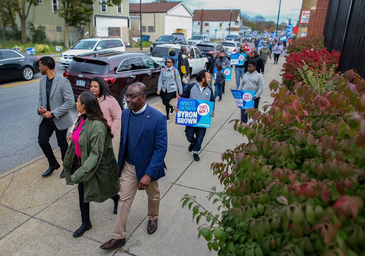 Buffalo, New York, Mayor Byron Brown (front right) leads supporters in a march to the polls on Oct. 23. He is banking on his reputation as a turnaround artist — and voters' fears of Walton.