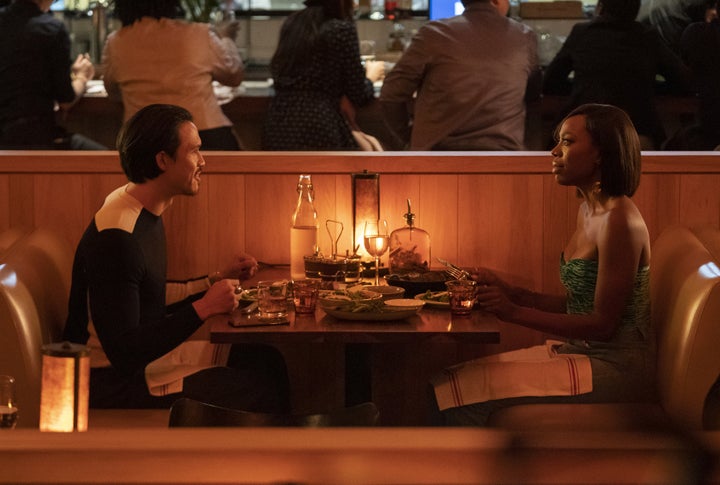 Lovebirds Andrew (Hodge) and Molly (Yvonne Orji) sit across from each other at dinner in Season 4, Episode 4.