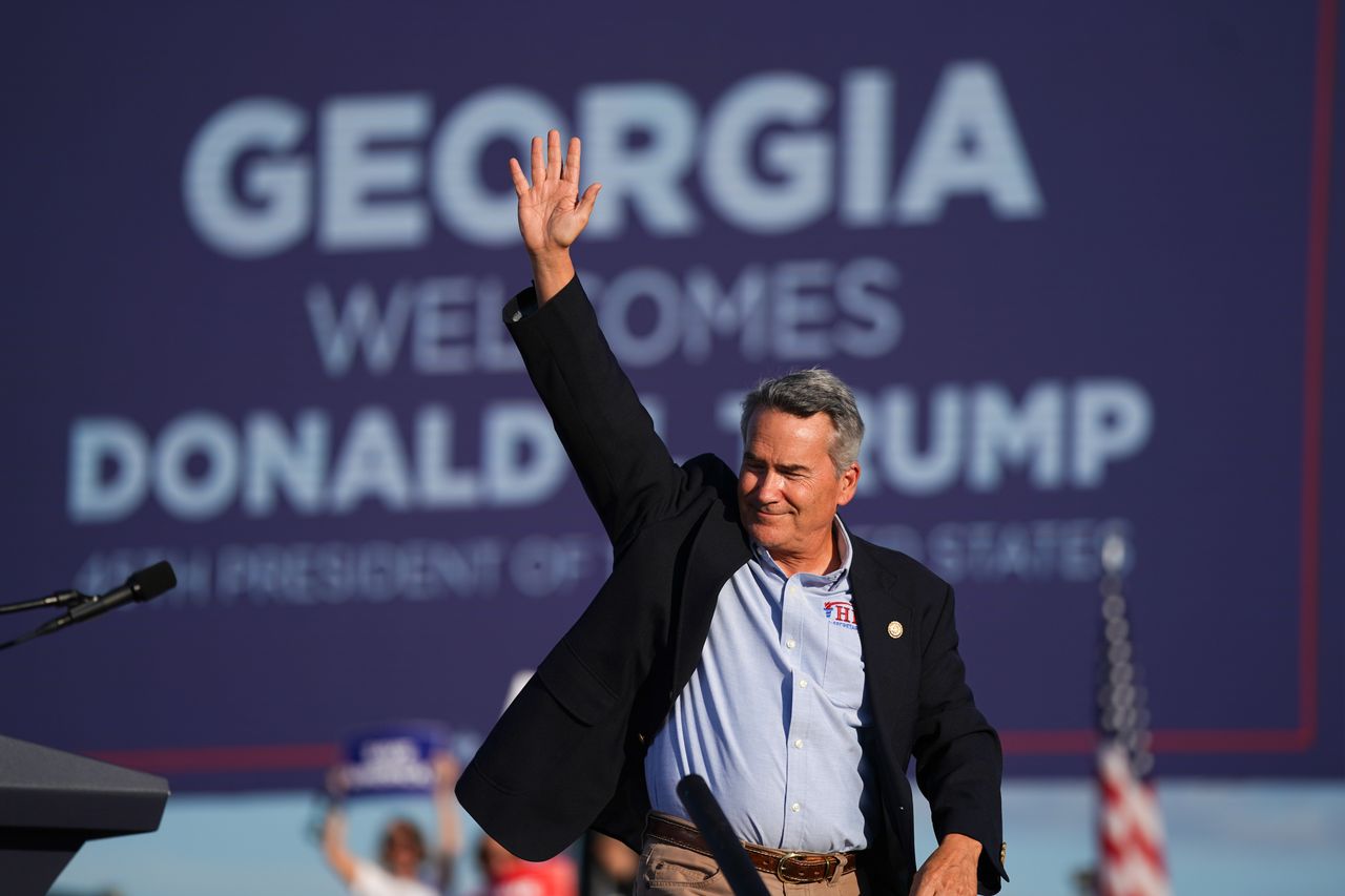 U.S. Rep. Jody Hice (R-Ga.), a candidate for Georgia secretary of state and a proponent of Trump's election lies, waves to the crowd during a rally featuring Trump on Sept. 25 in Perry, Georgia.