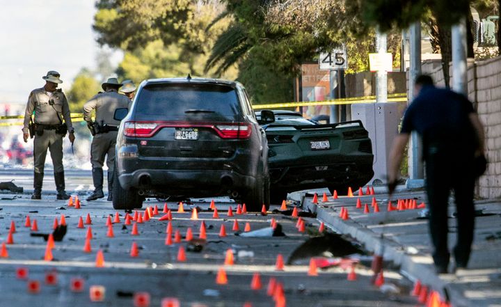 Las Vegas Metro Police investigators work at the scene of a fatal crash on South Rainbow Boulevard between Tropicana Avenue and Flamingo Road in Las Vegas, Tuesday, Nov. 2, 2021. (Steve Marcus/Las Vegas Sun via AP)