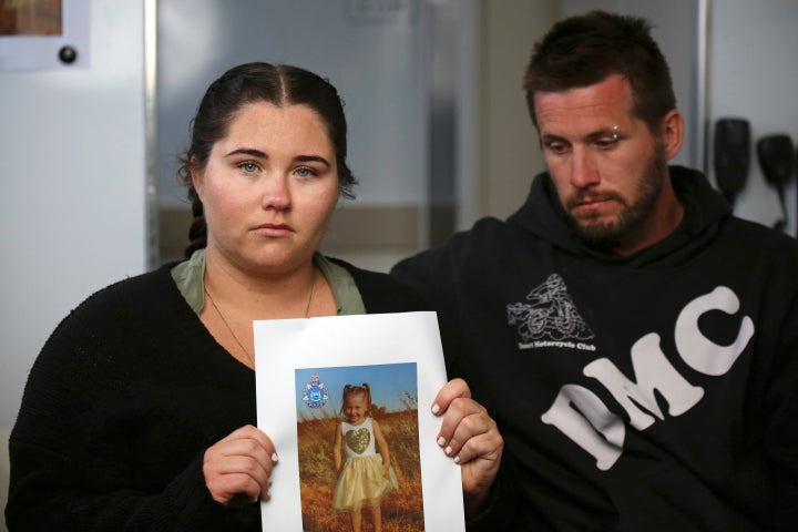 Ellie Smith, left, and her partner Jake Gliddon, displayed a photo of their missing daughter, Cleo, on Oct. 19, 2021.