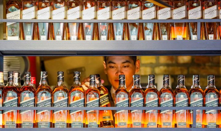  A bartender takes a bottle of Johnnie Walker whisky in Almaty, Kazakhstan June 22, 2017. REUTERS/Shamil Zhumatov/File Photo