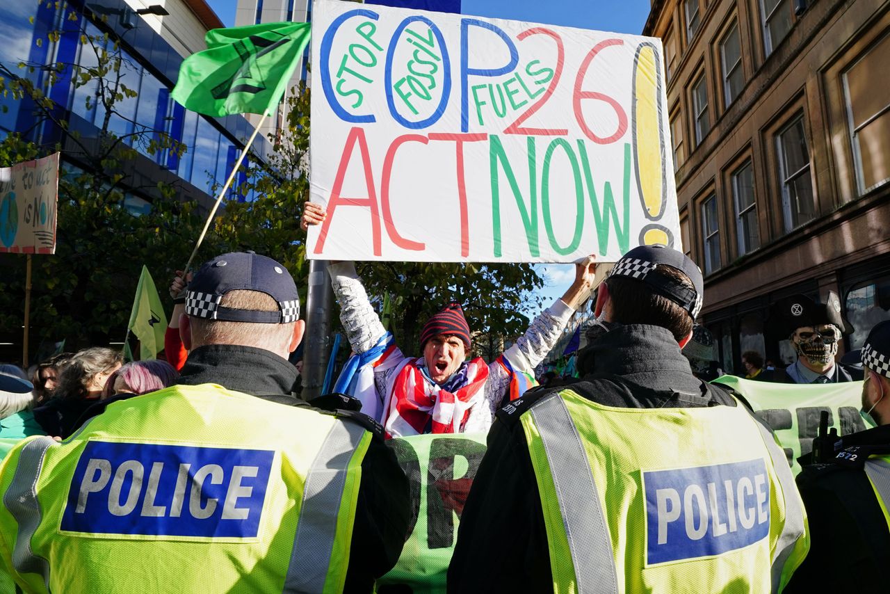 Police and demonstrators at a protest during the COP26 summit in Glasgow.