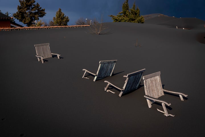 Ash covers chairs on the terrace of a house.