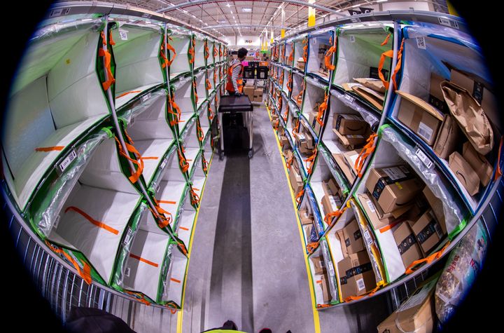 Employees sort parcels from online retailer Amazon at a distribution centre.