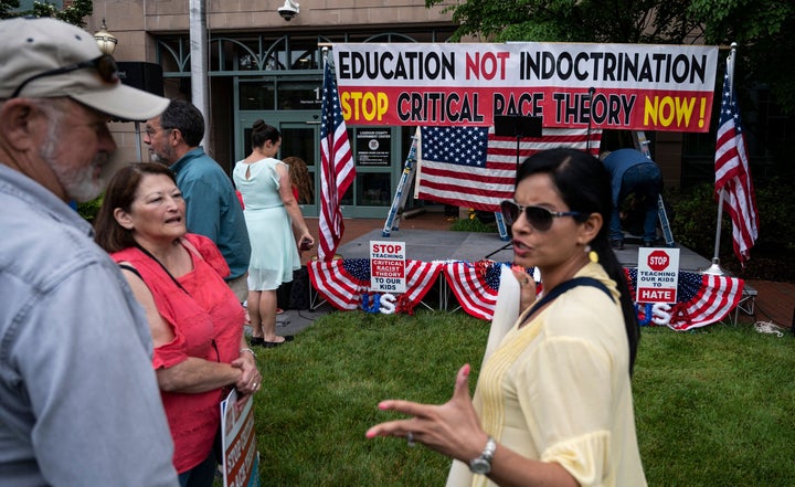 People talk before the start of a June 12 rally in Leesburg, Virginia, against "critical race theory" being taught in public schools.