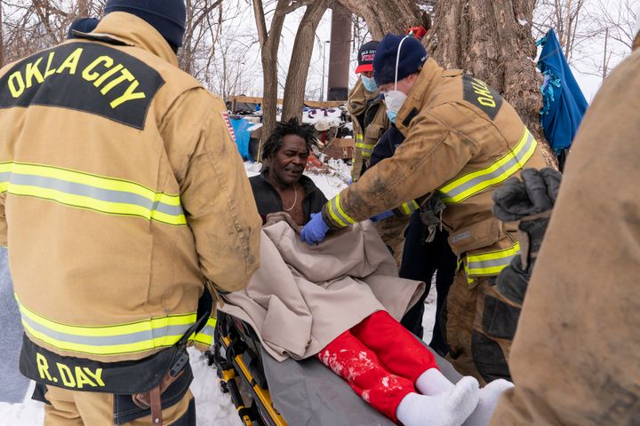Paramedics in Oklahoma City treat Eugene Rich for frostbite amid record-breaking cold and snow on Feb. 16.