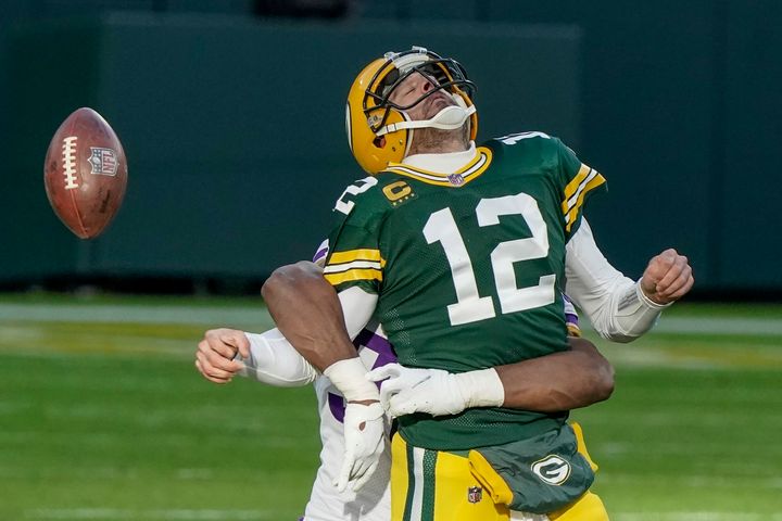 The Green Bay Packers' Aaron Rodgers fumbles the ball as he is hit by the Minnesota Vikings' D.J. Wonnum on Nov. 1, 2020, in Green Bay, Wisconsin.