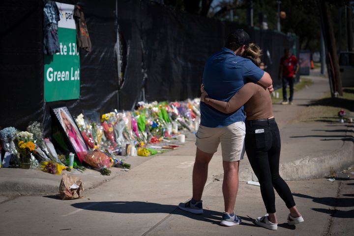 Two people who knew an unidentified victim of a fatal incident at the Houston Astroworld concert embrace at a memorial on Sunday, Nov. 7, 2021.