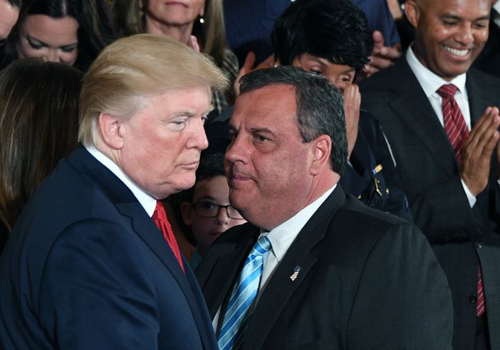 Governor Chris Christie(R-NJ) speaks with US President Donald Trump(L) after he delivered remarks on combatting drug demand and the opioid crisis on October 26, 2017