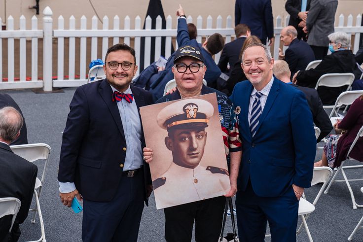 Vice chair of the California Democratic Party Davis Campos (left), LGBTQ activist Nicole Murray-Ramirez (center) and Bevan Dufty, director of the San Francisco Bay area rapid transit district, pose with a photo of Harvey before the launch of the USNS Harvey Milk in San Diego on Saturday.
