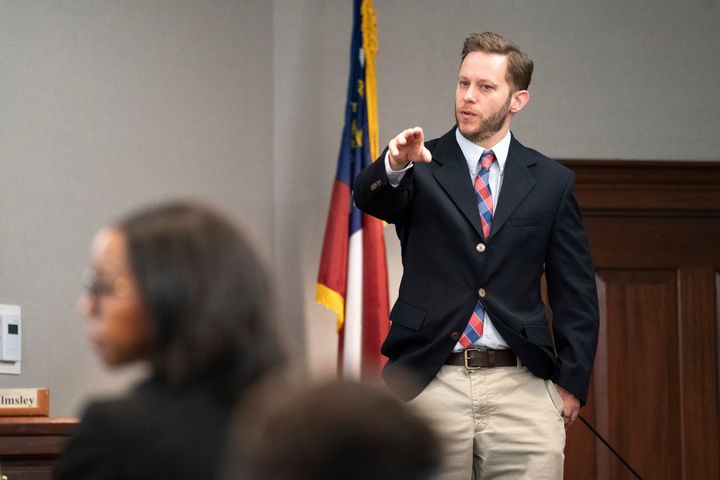 Former Glynn County police Officer Ricky Minshew points out defendant Travis McMichael during the trial for the shooting death of Ahmaud Arbery, Nov. 8, 2021, in Brunswick, Georgia.