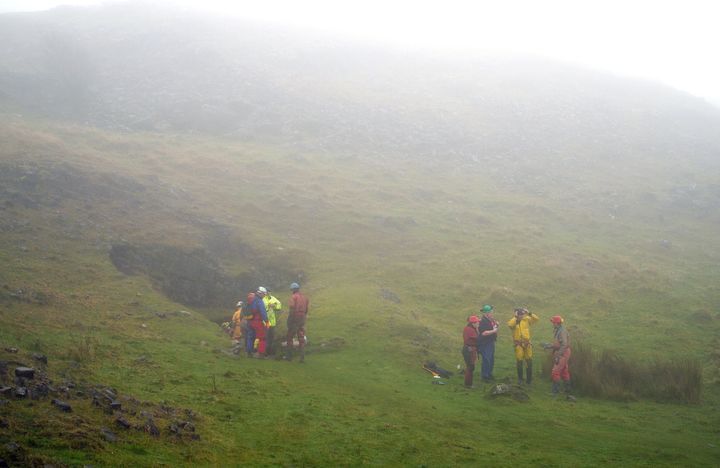 Rescuers at the entrance of the Ogof Ffynnon Ddu cave system near Penwyllt, Powys in the Brecon Beacons, Wales.