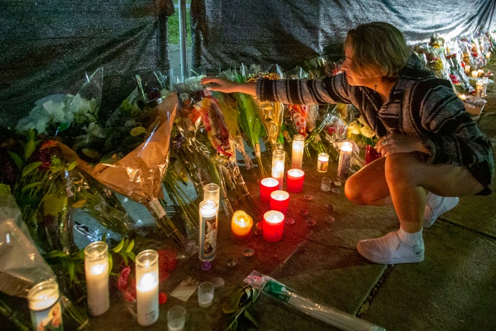 Hannah Longoria attends a makeshift memorial Sunday at the NRG Park grounds, where eight people died Friday in a crowd surge at the Astroworld Festival in Houston.