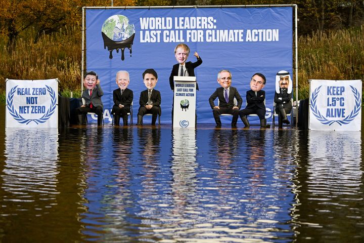 The Glasgow Actions Team activists dressed as world leaders sit on a raft in the Forth and Clyde canal on Nov. 9, 2021, in Glasgow, Scotland.