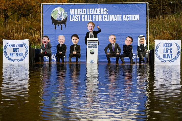 The Glasgow Actions Team activists dressed as world leaders sit on a raft in the Forth and Clyde canal on Nov. 9, 2021, in Glasgow, Scotland.