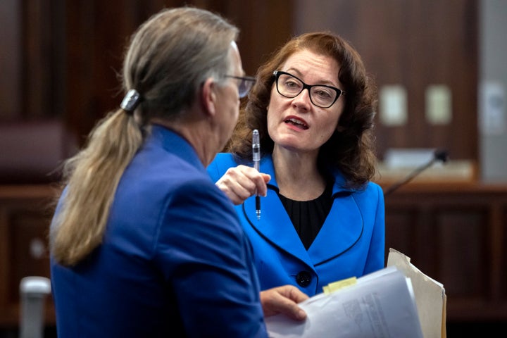 Defense attorney Franklin Hogue, left, and prosecutor Linda Dunikoski talk Tuesday before the trial of Greg McMichael, his son, Travis McMichael, and a neighbor, William "Roddie" Bryan at the Glynn County Courthouse in Brunswick, Georgia. The three white men are on trial for murder and other charges in the slaying of Ahmaud Arbery, who was chased and shot on Feb. 23, 2020.