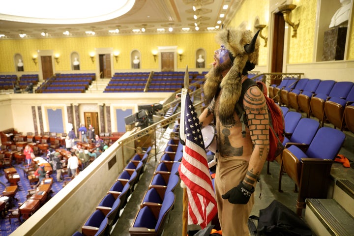 Chansley is seen inside the Senate chamber on Jan. 6.