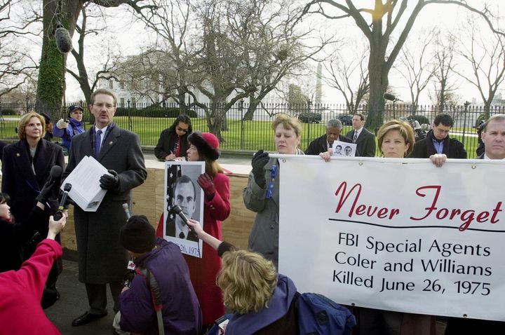 FBI agent and president of the FBI Agents Association John Sennett holds a petition with 9,500 names on it aimed at pressuring then-President Bill Clinton not to pardon Leonard Peltier during an incredibly unusual demonstration outside the White House on Dec. 15, 2000.