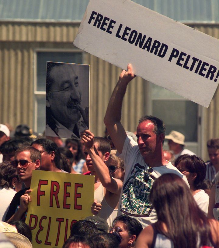 A group of people support Leonard Peltier during then-President Bill Clinton's speech on July 7, 1999, on the Pine Ridge Indian Reservation.