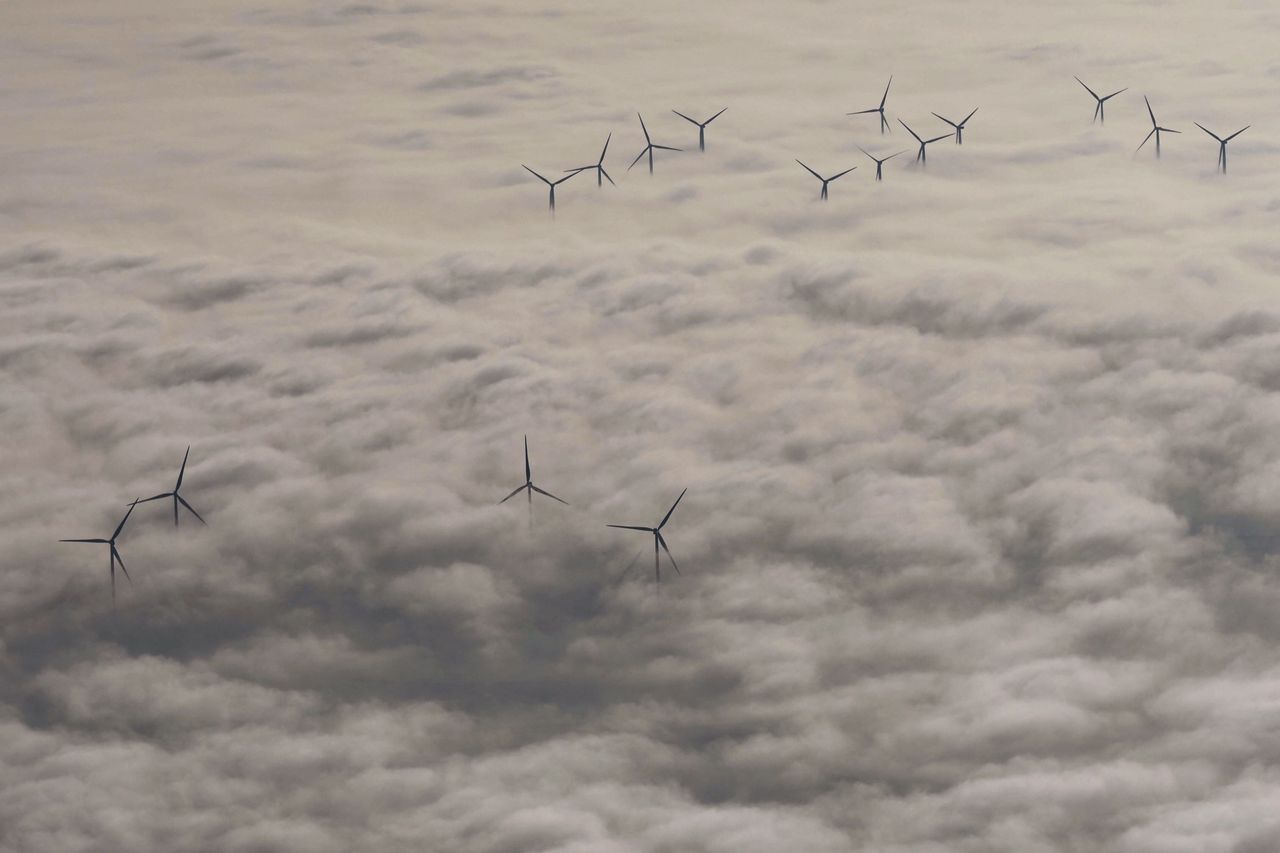 Wind turbines rise above the clouds in Chatellerault, western France, on Nov. 10.