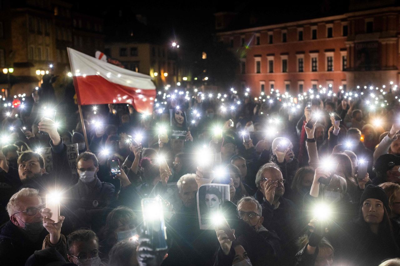 Protesters hold up lights, a Polish flag and a photograph of Iza as they take part in a demonstration in Warsaw to mark the first anniversary of a court ruling that imposed a near-total ban on abortion, and also to commemorate the death of pregnant Polish woman Iza, on Nov. 6. 