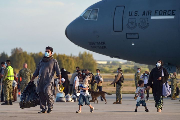 Refugees disembark from a U.S. Air Force aircraft after an evacuation flight from Kabul at the Rota naval base in Spain on Aug. 31. 