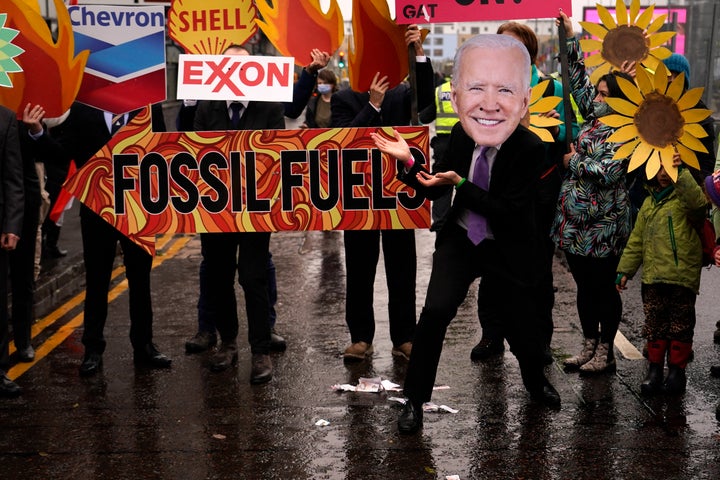 A climate activist wearing a mask of President Joe Biden takes part in a demonstration against the use of fossil fuels outside the venue for the COP26 U.N. Climate Summit in Glasgow, Scotland, on Friday.