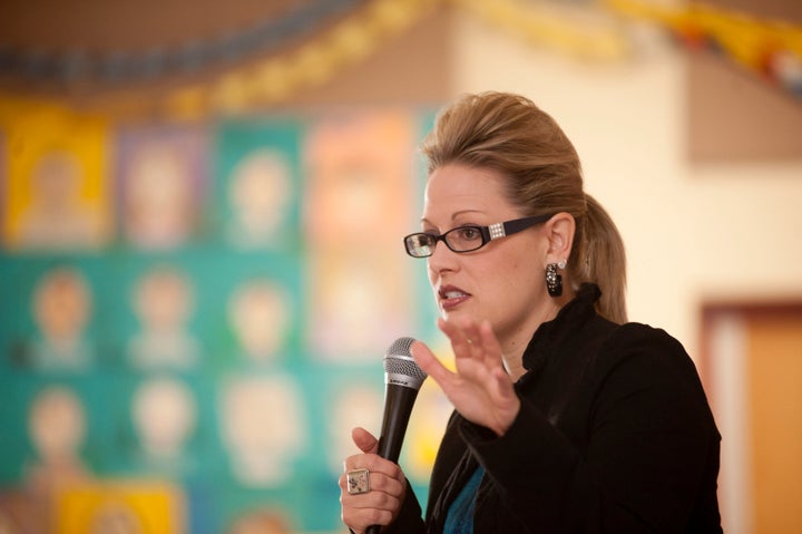 Then-U.S. Rep. Kyrsten Sinema talks to 8th graders at Arizona's Sunnyslope School where she once worked as a social worker.