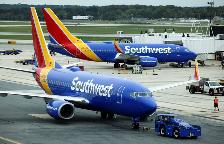 A passenger struck a Southwest Airlines operations agent in the head with a closed fist after the passenger was asked to leave the plane following a verbal altercation with another employee, authorities said.