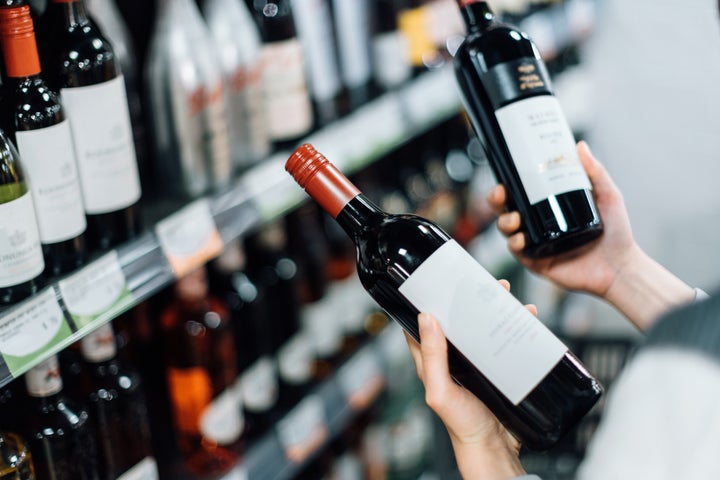 Una persona comprando vino.