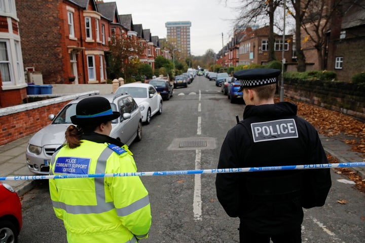 Police officers keep guard following a car blast outside Liverpool Women's Hospital