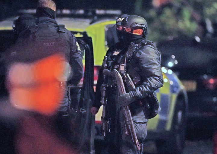 An armed officer holds a breaching shotgun near an address in Sefton Park, after an explosion at the Liverpool Women's Hospital
