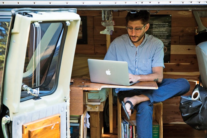 Danny Fenster works out of his van that he made into a home/office in Detroit in 2018.