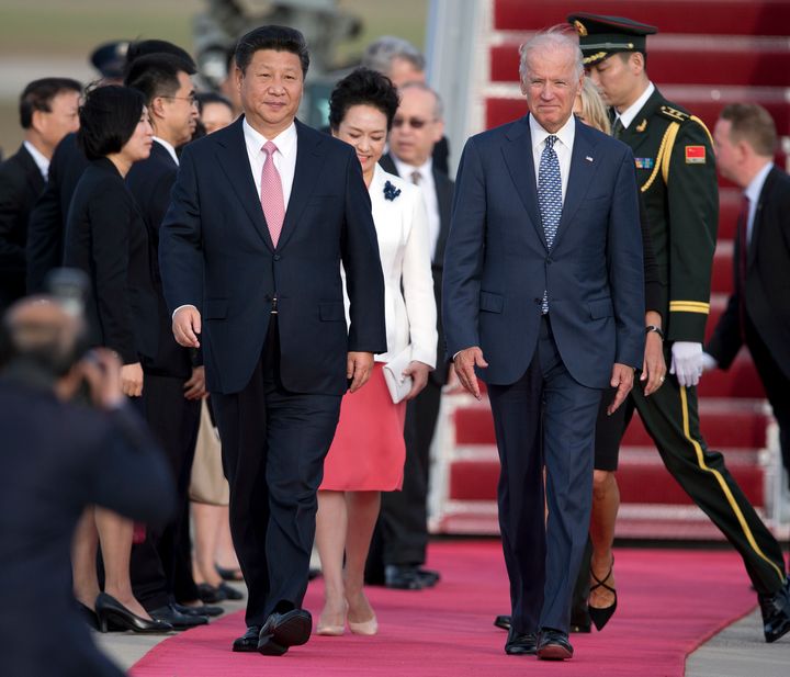 Chinese President Xi Jinping and Vice President Joe Biden walk down the red carpet on the tarmac during an arrival ceremony in Andrews Air Force Base, Md., Sept. 24, 2015. (AP Photo/Carolyn Kaster, File)
