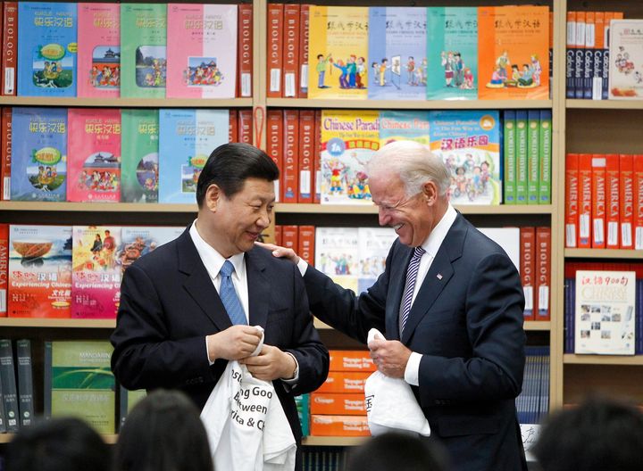 Chinese Vice President Xi Jinping and Vice President Joe Biden hold T-shirts students gave them at the International Studies Learning Center in South Gate, Calif., Feb. 17, 2012. (AP Photo/Damian Dovarganes, File)