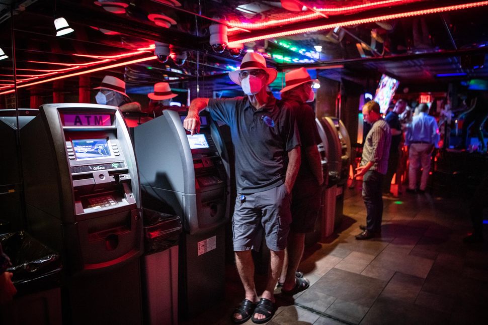 Joe Redner, the owner of the world-famous Mons Venus strip club in Tampa, Florida, poses by ATMs.