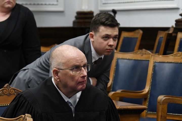 Judge Bruce Schroeder and Kyle Rittenhouse look at video screen as attorneys for both sides argue about a video during Rittenhouse's trial at the Kenosha County Courthouse in Kenosha, Wis., on Friday, Nov. 12, 2021. Rittenhouse is accused of killing two people and wounding a third during a protest over police brutality in Kenosha, last year. (Mark Hertzberg /Pool Photo via AP)
