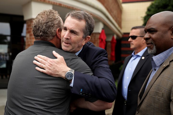 Virginia Gov. Ralph Northam (D) embraces a man after a mass shooting in Virginia Beach in June 2019. Democrats retook the legislature that year after running on tougher gun laws.