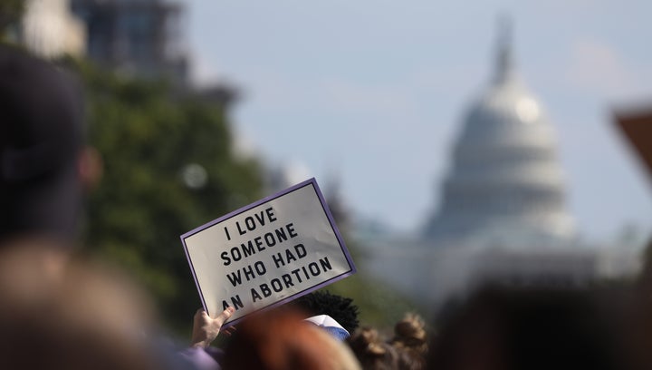 Women rights activists participate in the annual Women's March as they pass by the U.S. Supreme Court Oct. 2, 2021 in Washington, D.C.