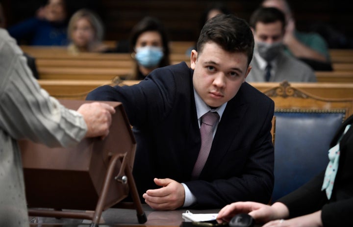 Kyle Rittenhouse pulls numbers of jurors out of a tumbler during his trial at the Kenosha County Courthouse on Nov. 16, 2021.