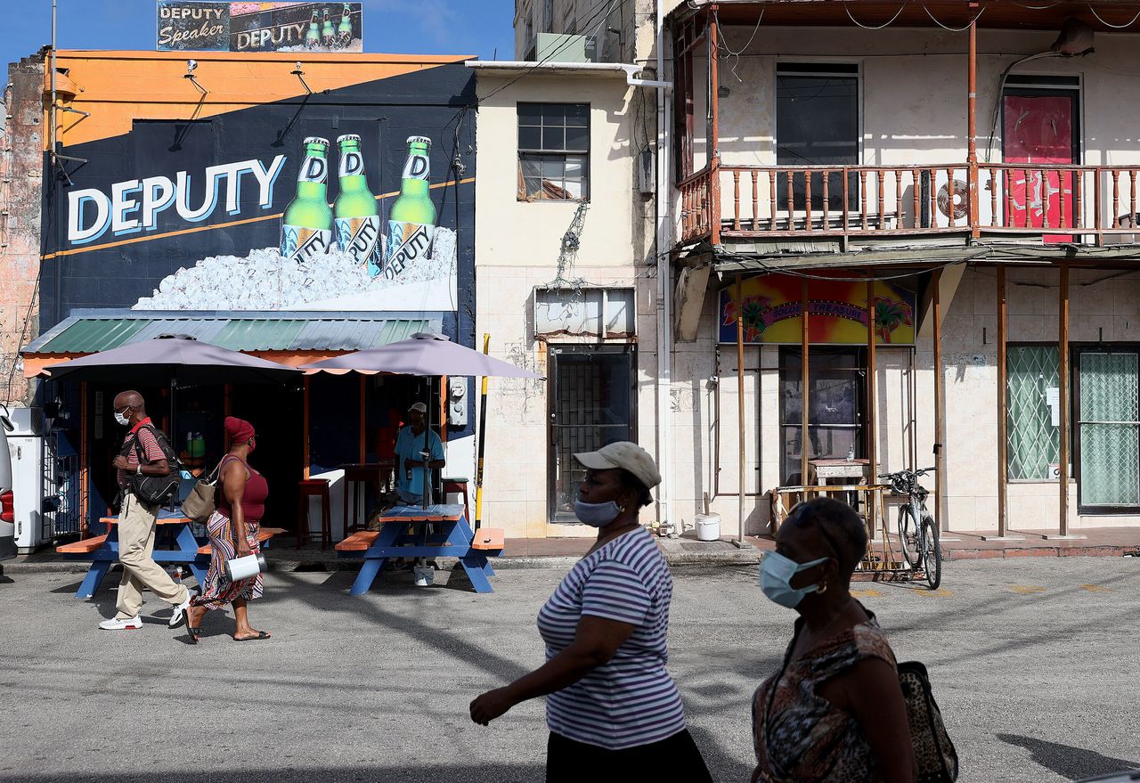 Pedestrians make their way through the streets of downtown in Bridgetown, Barbados. On Nov. 30, the 55th anniversary of the country’s independence from Britain, Barbados will remove Queen Elizabeth as head of state and swear in a local Barbadian president as head of state. In doing so, Barbados will become a republic.
