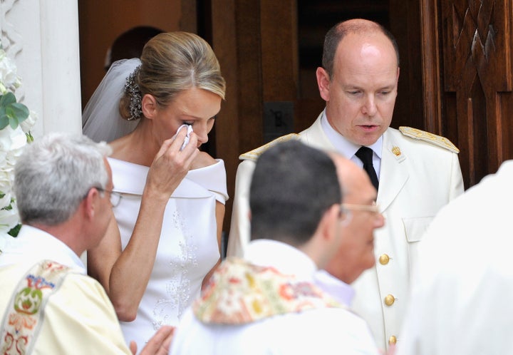 Princess Charlene of Monaco wipes away a tear as she and Prince Albert II of Monaco leave Sainte Devote church after their religious wedding ceremony at the Prince's Palace of Monaco on July 2, 2011 in Monaco.